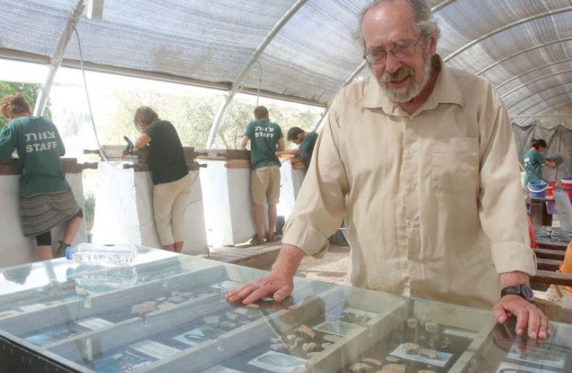 Barkay looks over priceless pieces of debris believed to date back to the First Temple period (photo credit: MARC ISRAEL SELLEM/THE JERUSALEM POST)