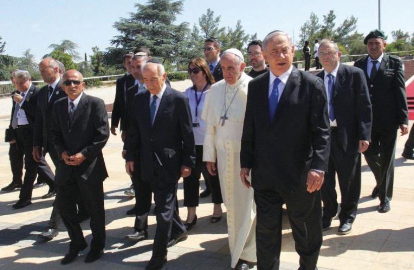 Pope Francis, flanked by former president Shimon Peres (left) and Prime Minister Benjamin Netanyahu, arrives at Mount Herzl during his visit to Israel last May. (photo credit: MARC ISRAEL SELLEM/THE JERUSALEM POST)