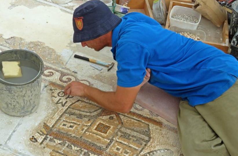 IAA workers conserve the rare mosaic (photo credit: NIKKI DAVIDOV, COURTESY OF THE ISRAEL ANTIQUITIES AUTHORITY)