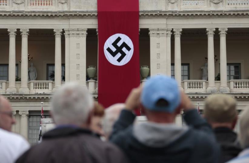 A Nazi swastika banner hangs on the facade of the Prefecture Palace in Nice which is being used as part of a movie set during the filming of a WWII film in the old city of Nice, France (photo credit: REUTERS)