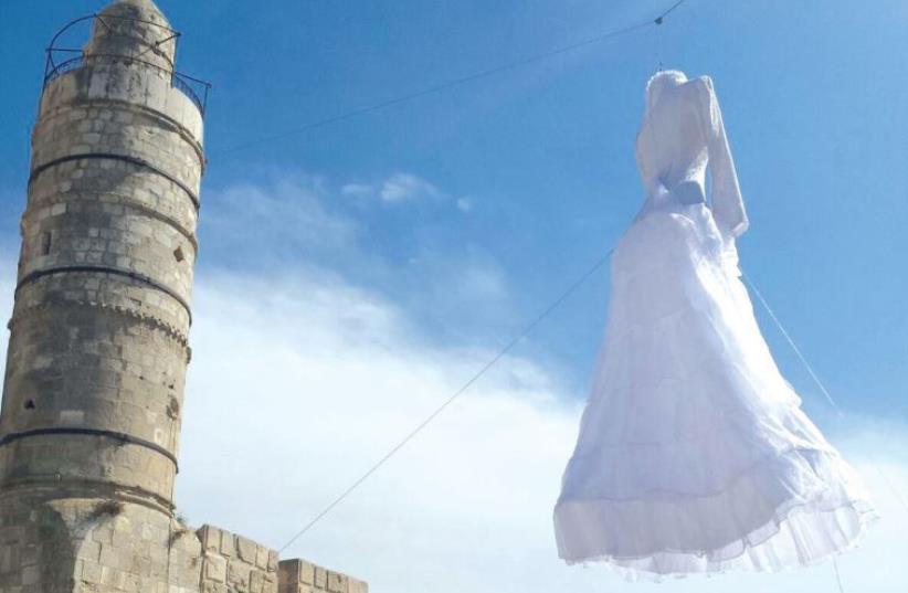 Motti Mizrahi’s five-meter-tall wedding dress flaps in the wind above the Citadel’s ramparts; on the biennale’s last day in November, it will be set free to drift over the Old City skyline (photo credit: RICKY RACHMAN)