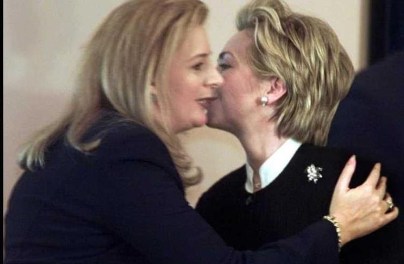When Suha concluded, Hillary embraced her warmly and planted affectionate kisses on her cheek.   (photo credit: REUTERS)