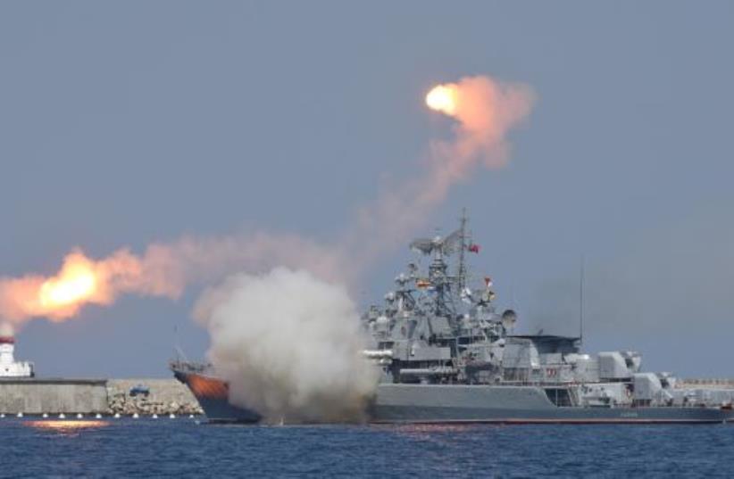 A Russian warship fires [File] (photo credit: REUTERS)