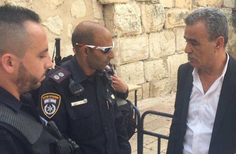 Zahalka with police officers banning him from Temple Mount (photo credit: Courtesy)