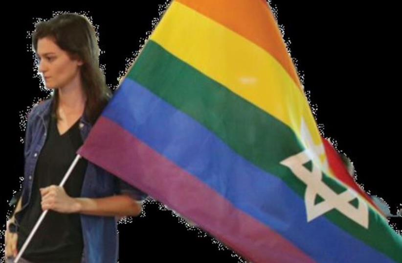 Sarah Weil waves the custom pride flag (photo credit: MARC ISRAEL SELLEM/THE JERUSALEM POST)