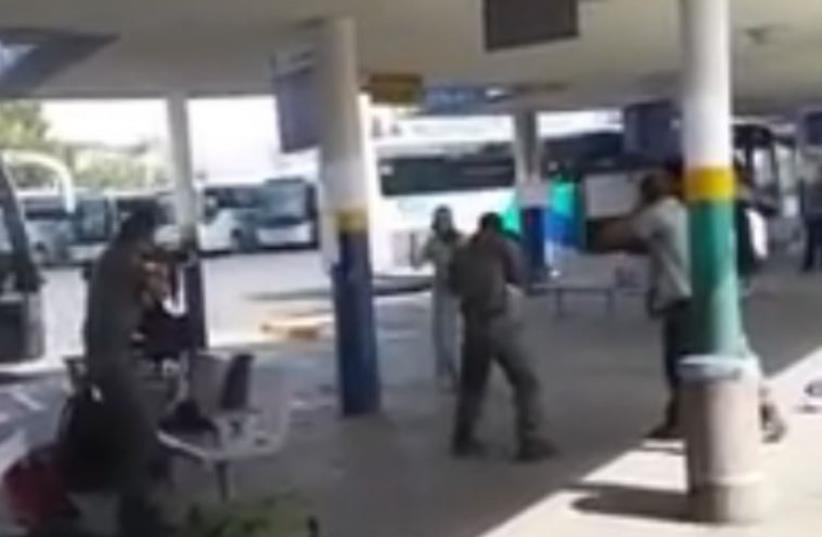 Police aim their weapons at a Palestinian woman armed with a knife at the Afula bus station (photo credit: Courtesy)