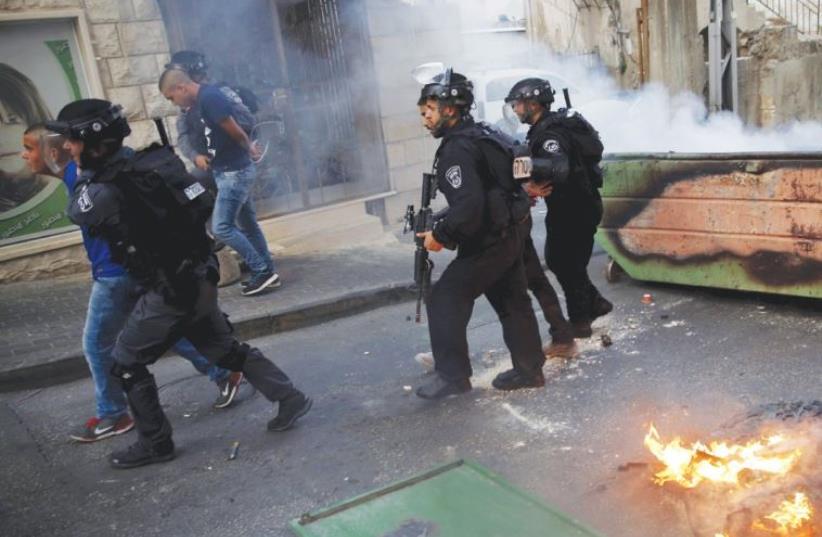 Police detain an Israeli-Arab rioter during disturbances in Nazareth (photo credit: REUTERS)