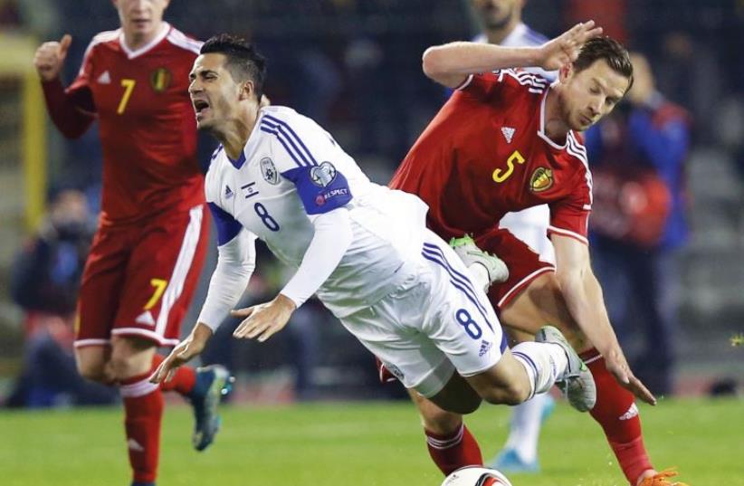 Israel midfielder Beram Kayal is tackled by Belgium’s Jan Vertonghen (right) during last night’s final Group B qualifying match in Brussels. (photo credit: REUTERS)