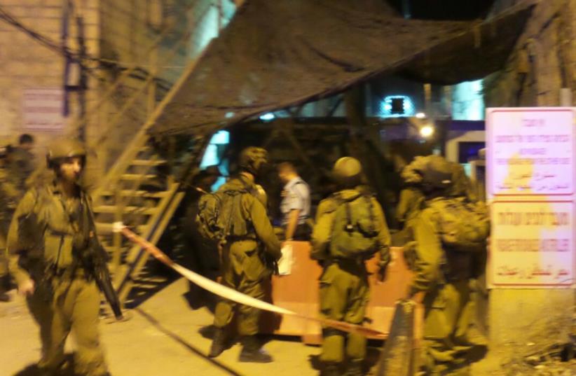 Terrorst stabbing in Hebron (photo credit: TZIPI SHLISSLE/TPS)