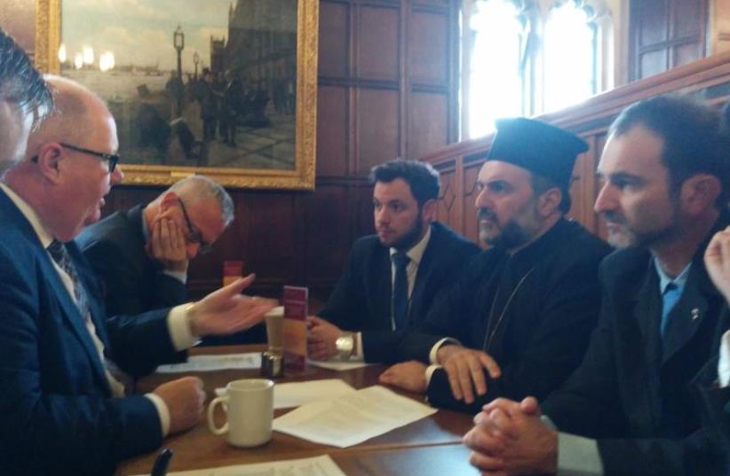 Father Gabriel Naddaf meets government officials in London (photo credit: Courtesy)