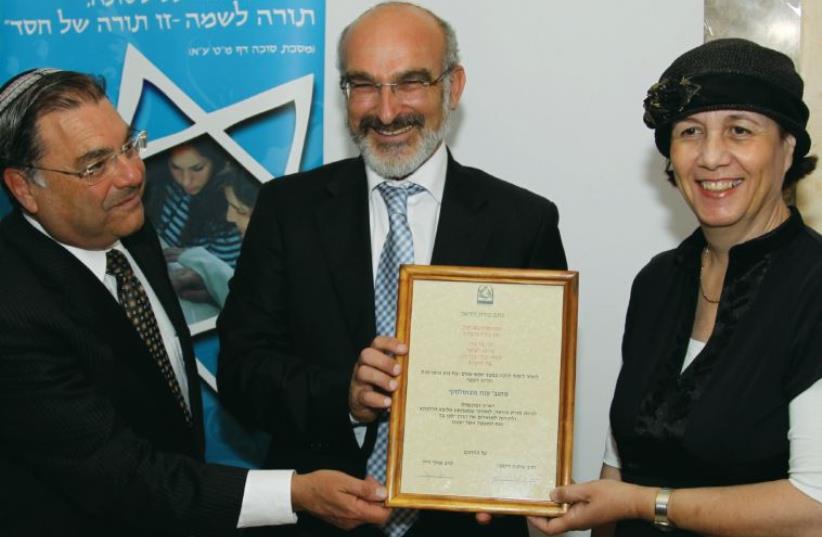 Anat Novoselsky receives her certification as a spiritual leader and arbiter of Jewish law from WIHL head Rabbi Shuki Reich (center) and OTS chancellor Rabbi Shlomo Riskin (photo credit: Courtesy)