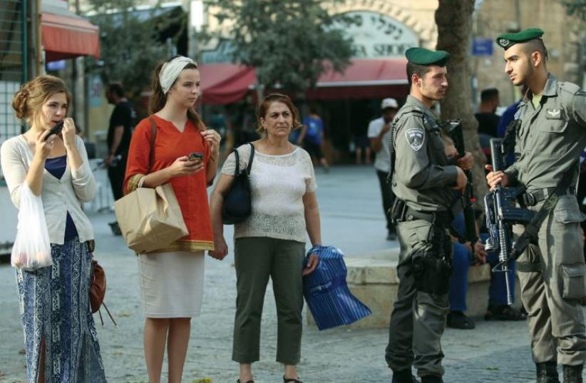 Soldiers guard pedestrians on Jaffa Road (photo credit: MARC ISRAEL SELLEM/THE JERUSALEM POST)