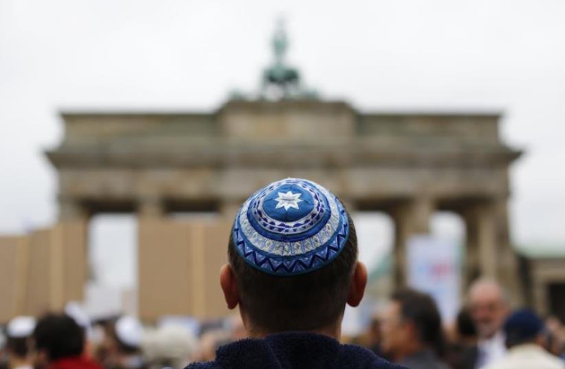 A man wearing a kippa waits for the start of an anti-Semitism demo at Berlin's Brandenburg Gate September 14, 2014 (photo credit: REUTERS)