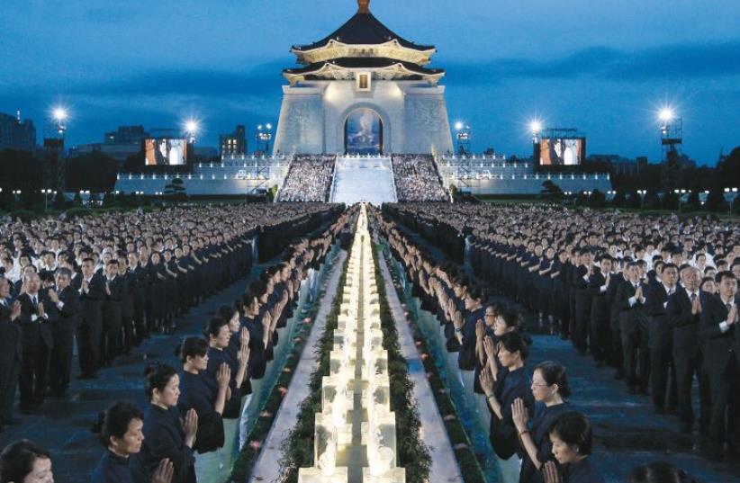 Buddhists pray at the Chiang Kai-shek Memorial Hall in Taipei (photo credit: REUTERS)