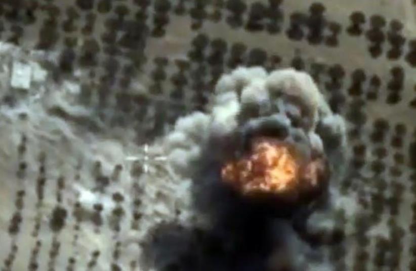 A video grab made on October 15, 2015, shows an image taken from a footage made available on the Russian Defence Ministry's official website, purporting to show an explosion after airstrikes carried out by Russian air force on what Russia says was an Islamic State facility in the Syrian province of  (photo credit: AFP PHOTO)