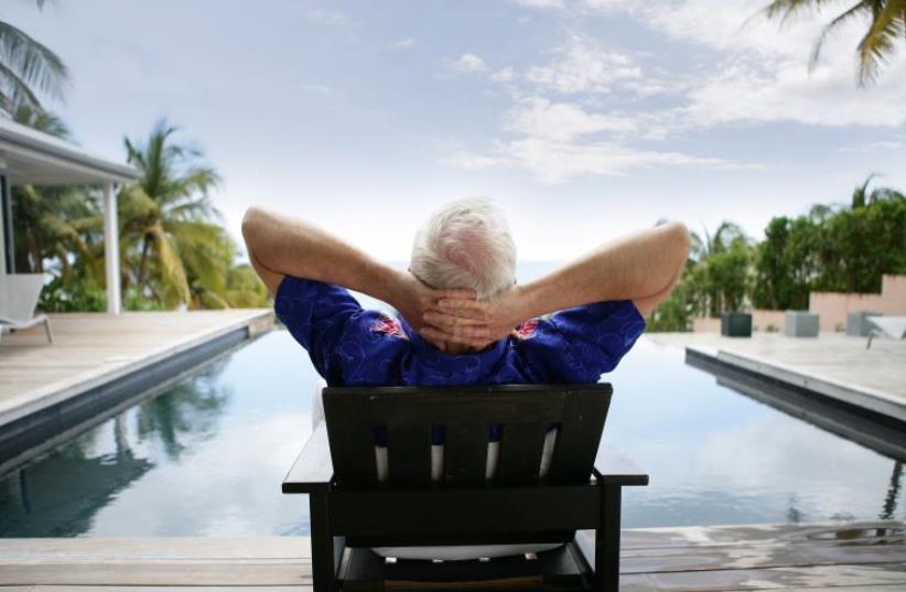 Illlustrative photo of a man relaxing on vacation (photo credit: INGIMAGE)