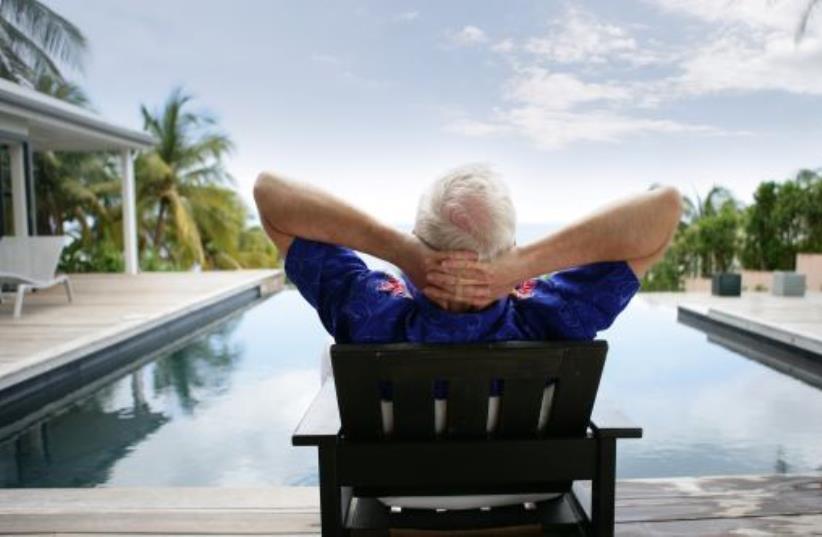 Illlustrative photo of a man relaxing on vacation (photo credit: INGIMAGE)