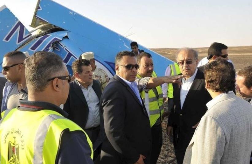 Egypt's Prime Minister Sherif Ismail (4rth R) at the remines of a plane crash at the desert in central Sinai near El Arish city north of Egypt, October 31, 2015 (photo credit: (AICF/CHRIS LEE))