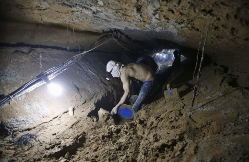 A Palestinian worker repairs a smuggling tunnel after it was flooded by Egyptian security forces, beneath the border between Egypt and southern Gaza Strip (photo credit: REUTERS)