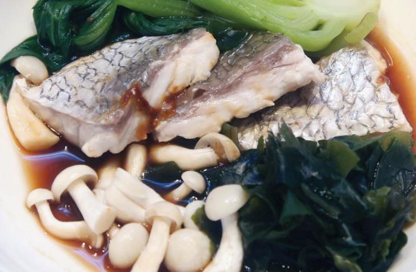 A fish fillet is marinated in Asian miso sauce and served with bok choy, seaweed and mushrooms (photo credit: MARC ISRAEL SELLEM/THE JERUSALEM POST)