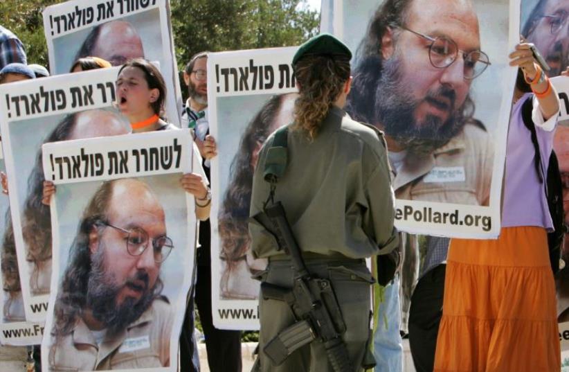Israeli protesters hold posters of Jonathan Pollard, who was convicted for spying on the United States in 1987, in front of the Israeli Prime Minister's office in Jerusalem June 19, 2005 (photo credit: AMMAR AWAD / REUTERS)