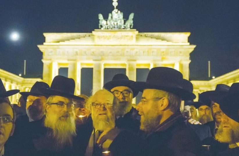 MEMBERS OF the Conference of European Rabbis carry candles in Berlin in 2013 to commemorate the 75th anniversary of Kristallnacht. (photo credit: REUTERS)