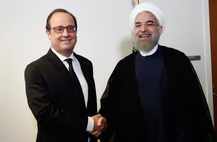 French President Francois Hollande (L) welcomes his Iranian counterpart Hassan Rouhani for a meeting during the 70th UN General Assembly on September 27, 2015, in New York (photo credit: ALAIN JOCARD / AFP)