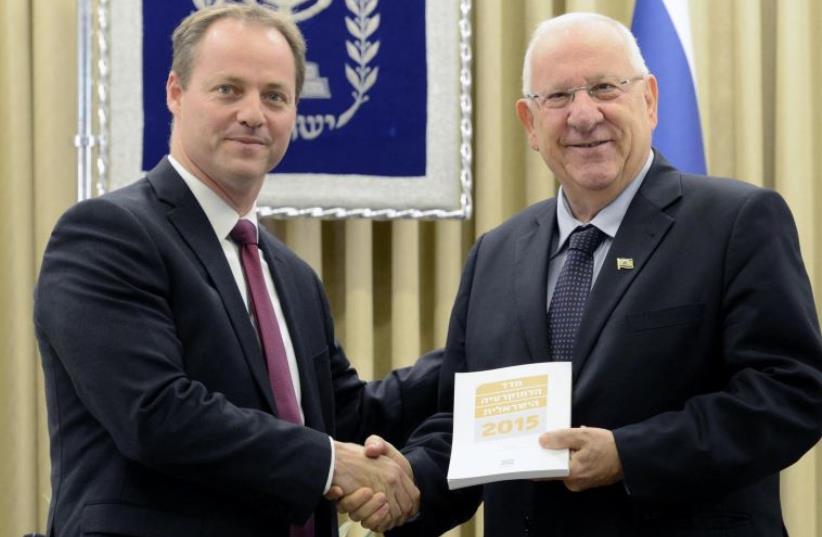 President Reuven Rivlin receives the Israeli Democracy Index for 2015 from Israeli Democracy Institute President Yohanan Plesner (photo credit: Mark Neiman/GPO)
