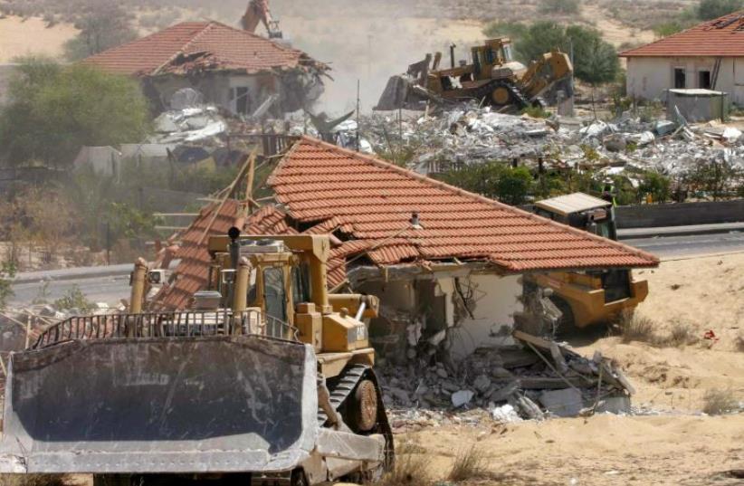 Bulldozers and earthmoving equipment demolish homes in the former Jewish settlement of Neve Dekalim, in the Gaza Strip August 31, 2005.  (photo credit: REUTERS)