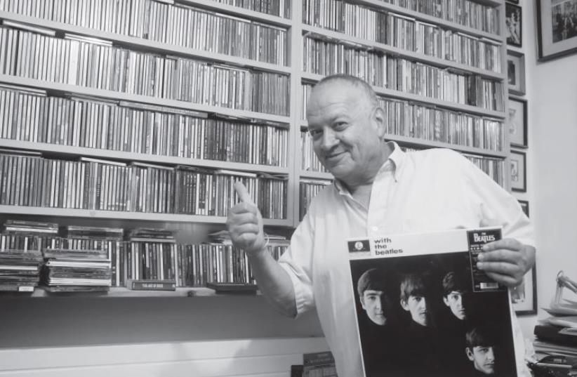 Benny Dudkevitch holds a ‘With The Beatles,’ one of his – and the country’s – first international records (photo credit: MARC ISRAEL SELLEM/THE JERUSALEM POST)