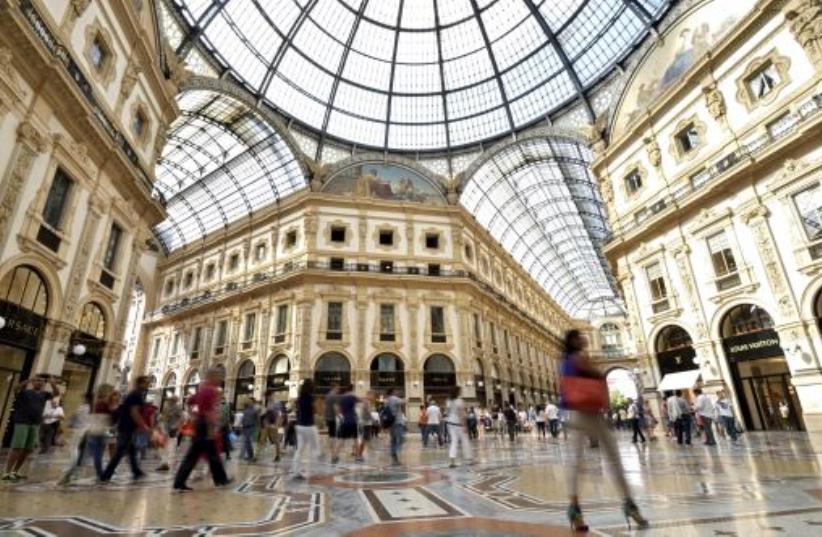People walk along the Galleria Vittorio Emanuele II shopping mall in Milan (photo credit: REUTERS)