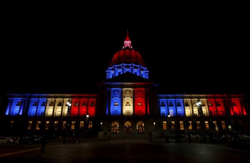 San Francisco City Hall is lit up with blue, white and red, the colors of the French flag, following the Paris terror attacks, in San Francisco, California November 13, 2015.  (photo credit: REUTERS)