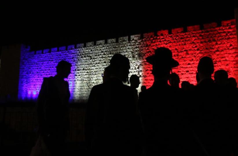 Wall of Jerusalem's old city lit up in colors of French flag (photo credit: MARC ISRAEL SELLEM/THE JERUSALEM POST)