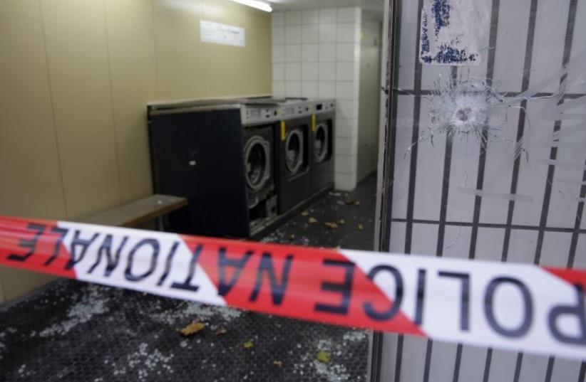 A launderette remains closed two days after an attack close by, in central east Paris, on November 15, 2015 (photo credit: KENZO TRIBOUILLARD / AFP)