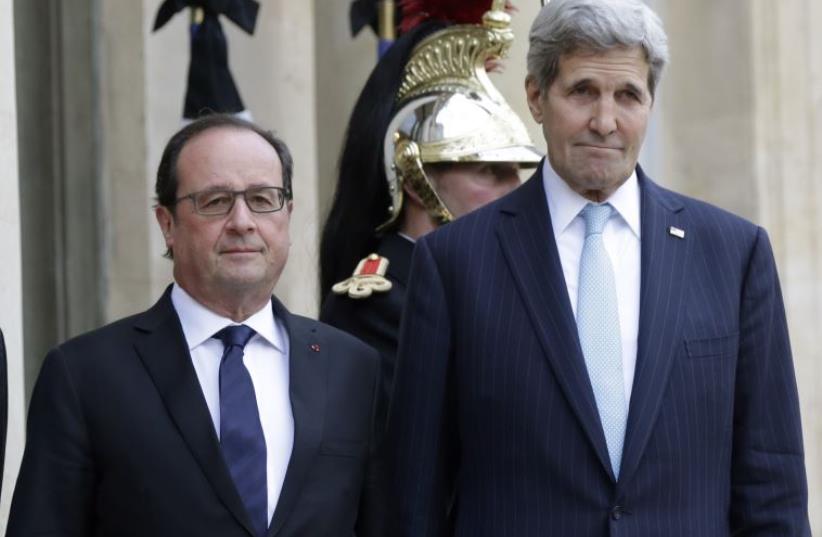 French President Francoise Hollande welcomes US Secretary of State John Kerry at the Elysee Palace in Paris (photo credit: REUTERS)