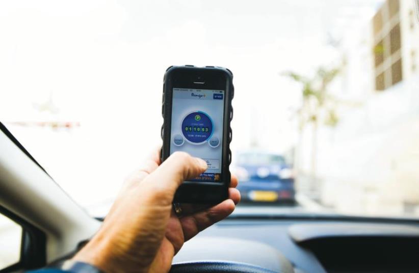 PANGO, an Israeli parking app, is seen on a smartphone in Jerusalem earlier this year. A band of young entrepreneurs, policy makers and investors are starting to change the Jerusalem ecosystem and bring it in line with Tel Aviv as a modern, hi-tech hub. (photo credit: REUTERS)