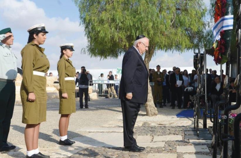 PRESIDENT REUVEN RIVLIN pays his respects at the commemoration ceremony in Sde Boker yesterday in memory of Israel’s founding prime minister, David Ben-Gurion. (photo credit: Mark Neiman/GPO)
