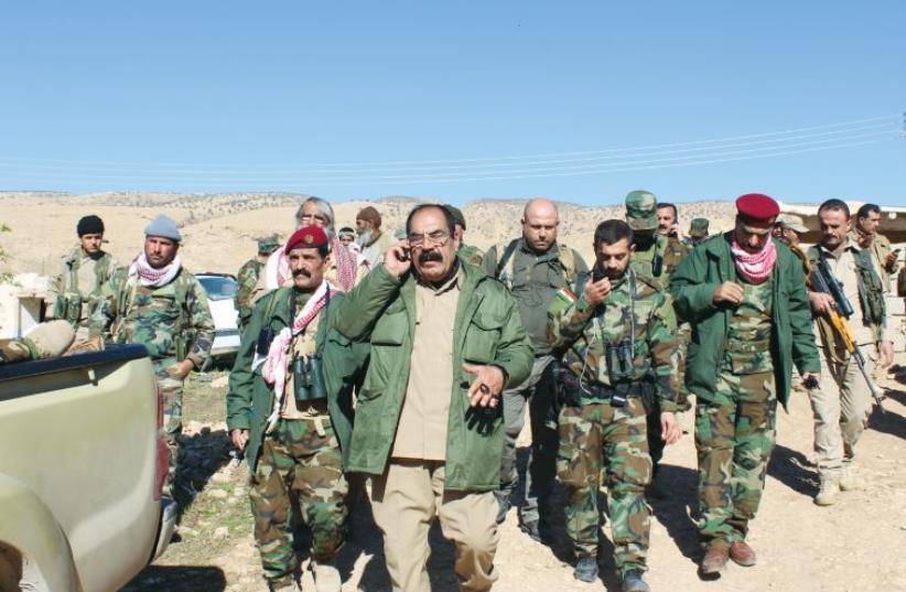 Yazidi commander Qasim Shesho leads Yazidi and Peshmerga soldiers (photo credit: VAGER SAADULLAH)