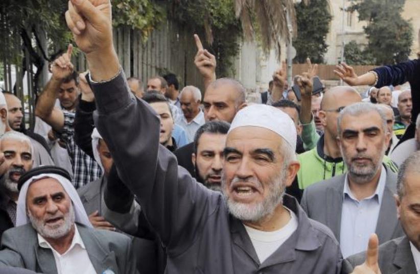 Leader of the northern Islamic Movement Sheikh Raed Salah gestures after leaving the district court in Jerusalem October 27, 2015. (photo credit: AMMAR AWAD/REUTERS)
