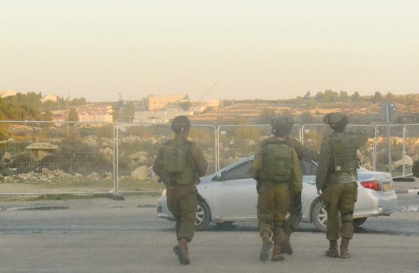 IDF soldiers secure the perimeter of the traffic circle at the Gush Etzion junction during a demonstration by residents (photo credit: LAURA KELLY)