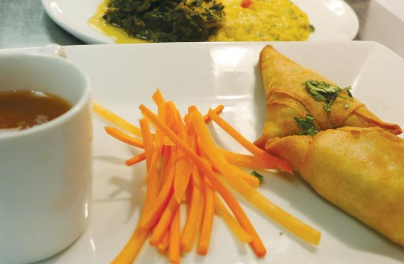 Samosas served with soup at Fifty2Fifty, a restaurant run by culinary students (photo credit: YAKIR LEVY)