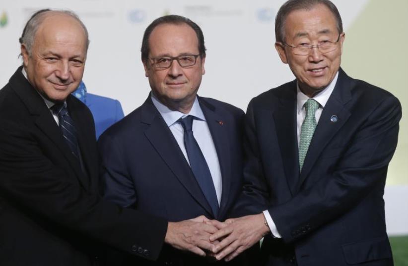French President Francois Hollande (C) and French Foreign Affairs Minister Laurent Fabius (L) welcome United Nations Secretary General Ban Ki-moon as he arrives for the opening day of the World Climate Change Conference 2015 (photo credit: REUTERS)