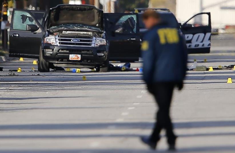 FBI and police continue their investigation around the area where two suspects were shot by police following a mass shooting in San Bernardino, California  (photo credit: REUTERS)
