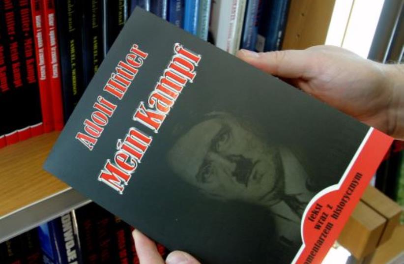 A customer holds a Polish copy of Adolf Hitler's Mein Kampf at a book store in Wroclaw, south western Poland February 23, 2005 (photo credit: REUTERS)