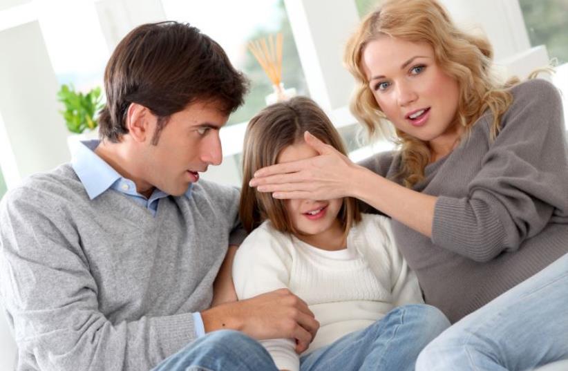 Parents preventing child from watching violent movie (photo credit: INGIMAGE)
