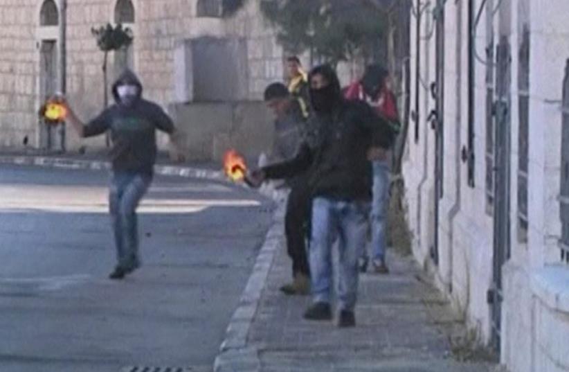 Palestinians stone throwing youths clash with Israeli troops (photo credit: REUTERS)
