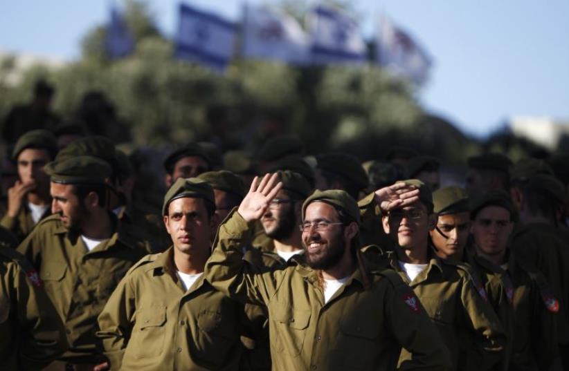 IDF soldiers of the Netzah Yehuda Haredi infantry battalion are seen during their swearing-in ceremony in Jerusalem (photo credit: REUTERS)