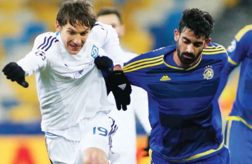 Dynamo Kiev’s Denys Garmash (left) scored the only goal in last night’s 1-0 victory over Maccabi Tel Aviv and Omri Ben Harush in Champions League action in Ukraine (photo credit: REUTERS)