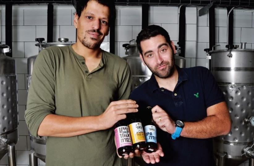 Herzl Beer partners Itai Gutman (left) and Maor Helfman in their Jerusalem brewery (photo credit: MIKE HORTON)