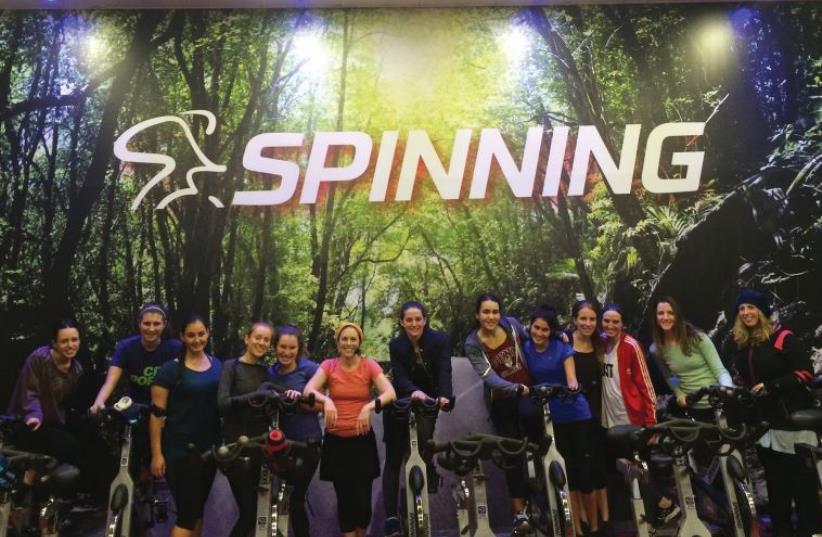 Attendees, mostly seminary students from North America, flank Benovitz at the December 5 spin class (photo credit: CHANTAL BELZBERG)